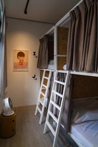 Katil atau katil-katil dalam bilik di 暖南小安民宿The Warm Tain-An Hostel-台南火車站-新樓醫院-背包客房-可包層-可包房-可包棟-獨旅友善民宿