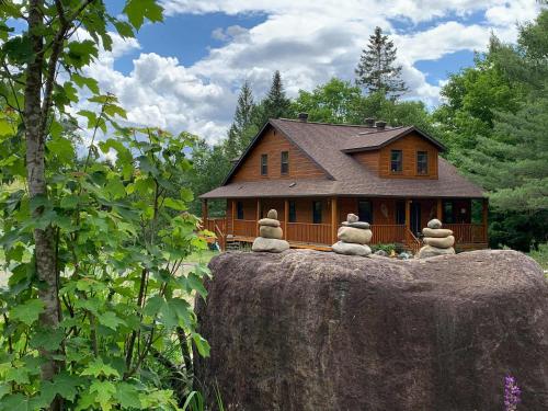 a group of stuffed animals sitting on top of a large rock at Domaine Bonheura - Spa & Swimming Pool in Val-David