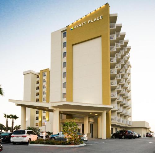 a hotel building with cars parked in a parking lot at Hyatt Place Daytona Beach-Oceanfront in Daytona Beach