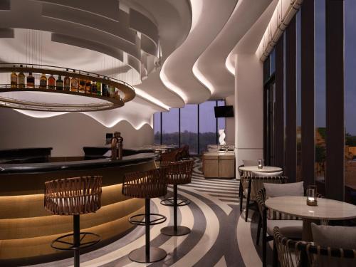 a rendering of a restaurant with tables and chairs at Beihai Marriott Resort in Beihai