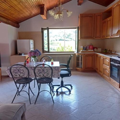a kitchen with a table and chairs in a kitchen at Casa vacanze Ca' Rizzoli in Berbenno