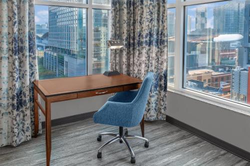 a desk with a blue chair in a room with a window at Hilton Garden Inn Nashville Downtown Convention Center in Nashville