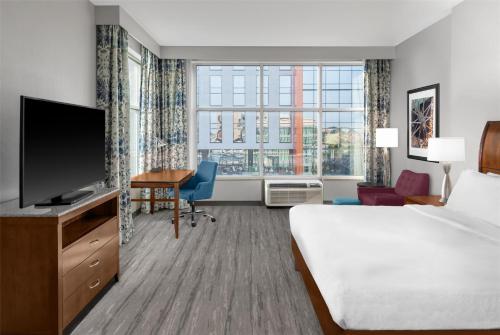 a hotel room with a bed and a flat screen tv at Hilton Garden Inn Nashville Downtown Convention Center in Nashville