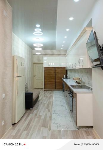 a kitchen with a sink and a refrigerator at Cozy Stay in Dushanbe