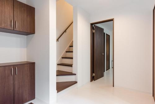 a hallway of a house with stairs and a door at Gracias Arakawa - Great Access to UENO & ASAKUSA area in Tokyo
