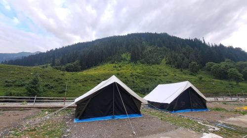 two tents sitting on top of a hill at Glamping by Stay Pattern in Sonāmarg