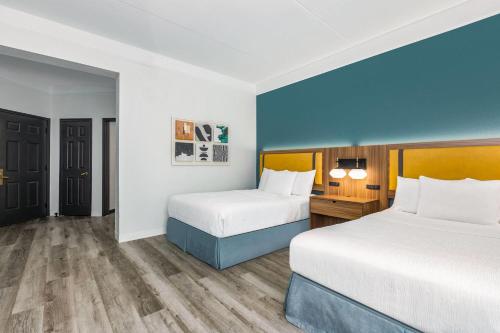 a hotel room with two beds and a desk at La Quinta by Wyndham Sherman in Sherman
