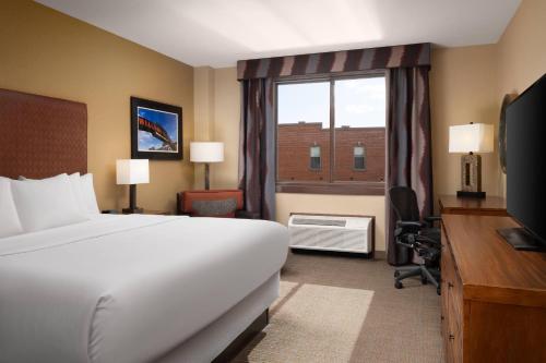 a hotel room with a bed and a window at The Golden Hotel, an Ascend Collection Hotel in Golden