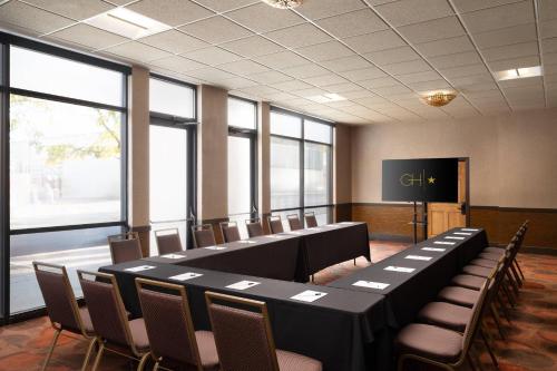 a conference room with a long table and chairs at The Golden Hotel, an Ascend Collection Hotel in Golden