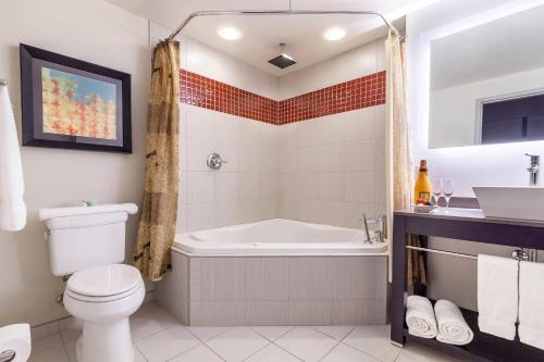 a bathroom with a tub and a toilet and a sink at Cambria Hotel Pittsburgh - Downtown in Pittsburgh
