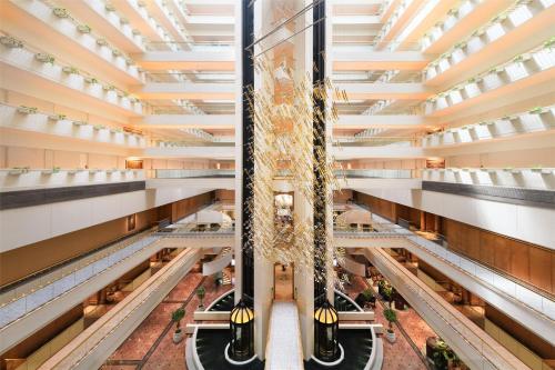 an overhead view of a shopping mall with escalators at Conrad Singapore Orchard in Singapore