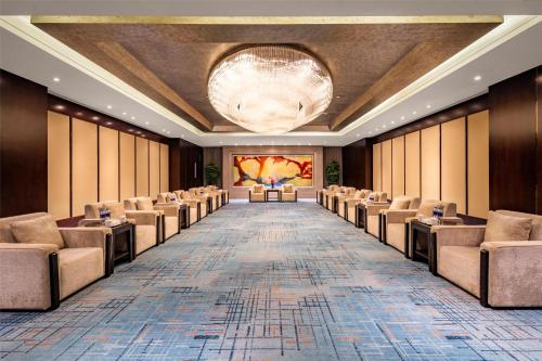 a large room with chairs and a large chandelier at Kempinski Hotel Xiamen in Xiamen