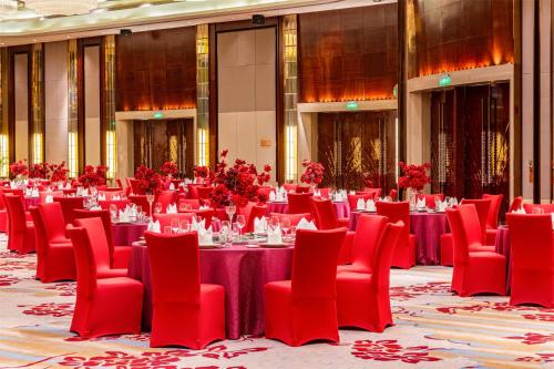 a banquet hall with red tables and red chairs at Kempinski Hotel Xiamen in Xiamen
