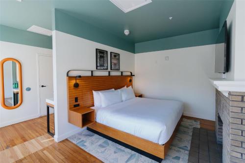 a bedroom with a large bed with a wooden headboard at The Myriad Hotel Louisville, Tapestry Collection by Hilton in Louisville
