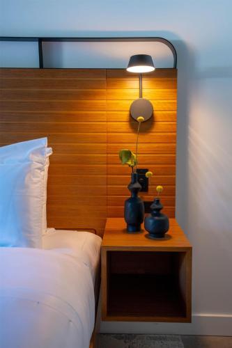 a bedroom with a bed and a lamp on a table at The Myriad Hotel Louisville, Tapestry Collection by Hilton in Louisville