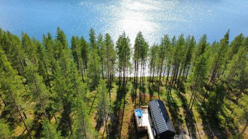 an aerial view of a truck driving through a forest at Hossaville Luxe Lake Cabin in Hossa