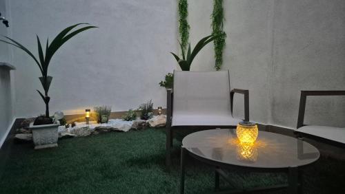 a living room with a white chair and a table at La Casa di Athina 2 in Celano