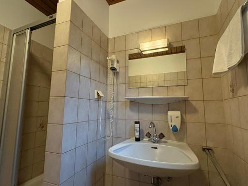 a bathroom with a sink and a shower at Edelweiss Lodge Lachtal I Self Check-in in Lachtal