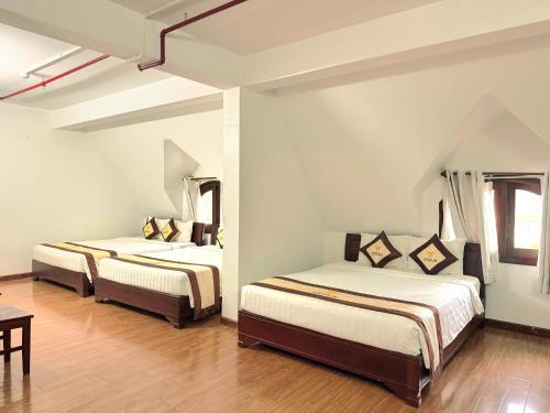 Una cama o camas en una habitación de Venus Phu Quoc Hotel