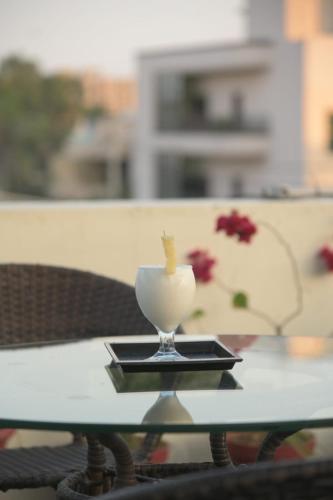 a glass cup on a tray on a table at The Elet Signature Boutique Hotel in Karachi