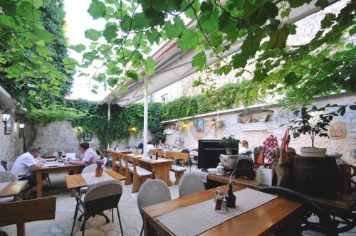 a restaurant with tables and people sitting at tables at Palace Central Square in Trogir