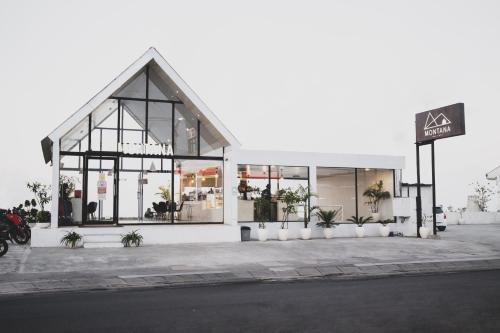a white building with plants in front of it at El Lago Hotel in Kintamani
