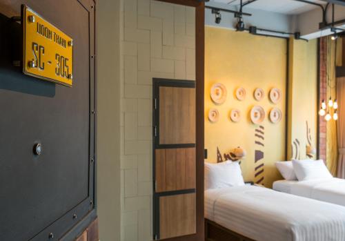 a room with two beds and a sign on the wall at Sea Crest by Jomtien in Jomtien Beach