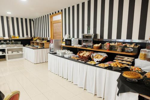 a buffet line with many different types of food at Hotel Ciudad Cangas de Onis in Cangas de Onís