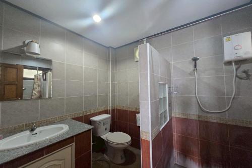 a bathroom with a shower and a toilet and a sink at Phaiboon Hotel & Resort in Pak Chong