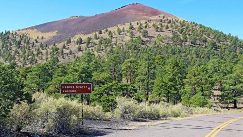 a sign on the side of a road in front of a mountain at Gorgeous Historic 3 BR Log Cabin w Forest Views 20 Minutes from Flagstaff Now with Wi-Fi in Parks