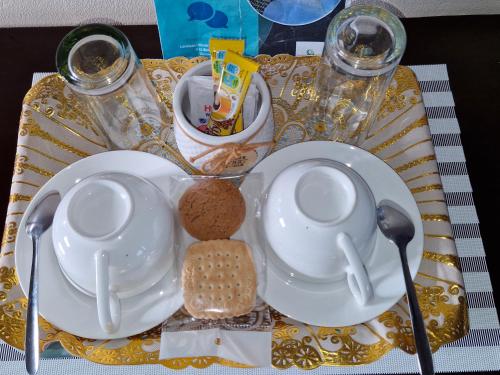 a table with plates and spoons on a table at Lormasol Mews Guesthouse in Serowe