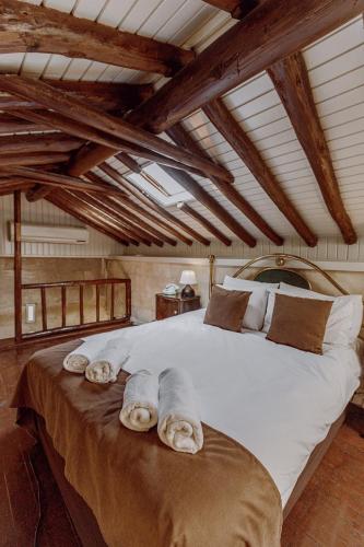a bedroom with a large bed with towels on it at Anadolu Evleri in Gaziantep