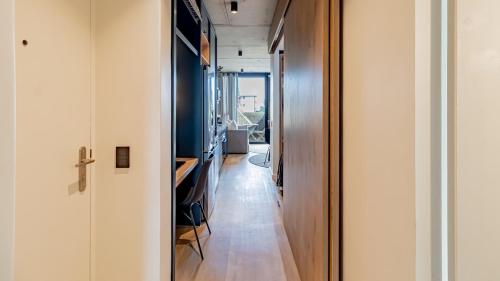 a hallway leading to a living room with a hallway at Designer apartment in Sea Point with rooftop pool in Cape Town
