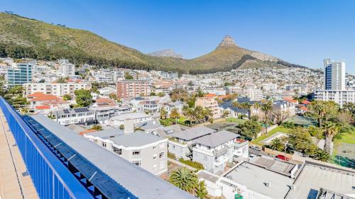 a view of a city with mountains in the background at Designer apartment in Sea Point with rooftop pool in Cape Town