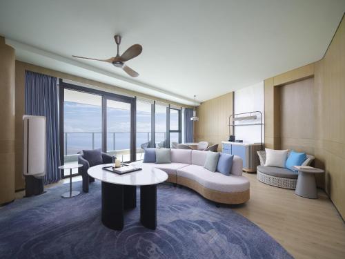 a living room with a couch and a table at Beihai Marriott Resort in Beihai