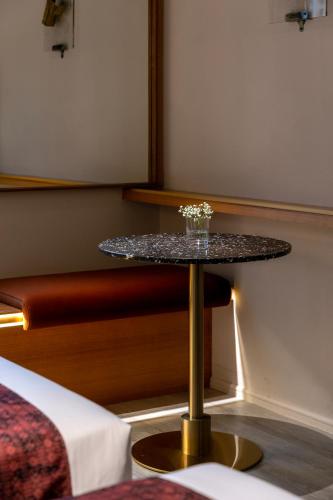 a small table in a room with a bed at Bintang Collectionz Hotel in Kuala Lumpur