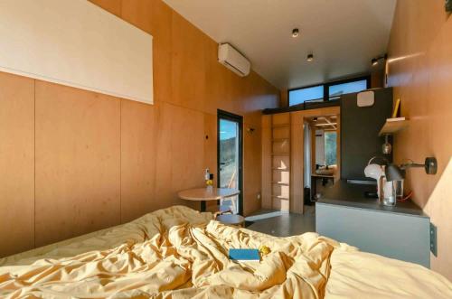 a bedroom with a bed and a table in it at Дзеркальний будинок Botan in Malaya Bugayevka