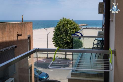 a balcony with a view of the beach at Daria Boutique Hotel in Eforie Sud