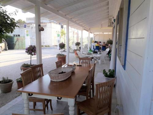 a wooden table and chairs on a patio at Gli Oleandri in Ginosa Marina