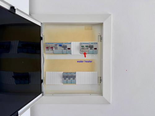an open refrigerator with a red arrow in it at Athenian Sky in Athens
