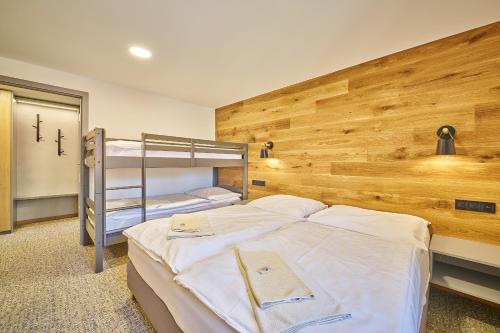 a bedroom with two bunk beds in it at Hotel Bouda Jana in Pec pod Sněžkou
