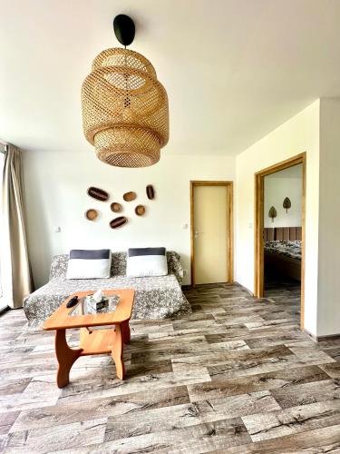 a bedroom with a bed and a table at Dolpo 55 in Benešov