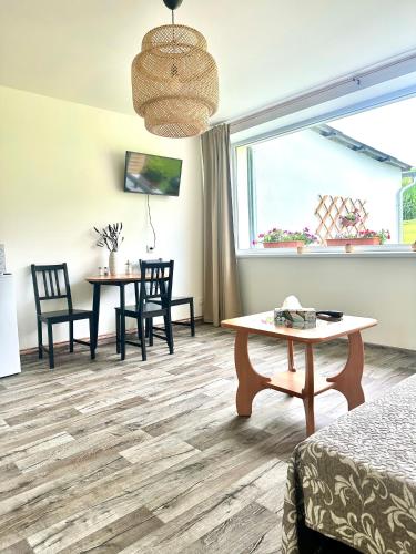 a room with a table and chairs and a window at Dolpo 55 in Benešov