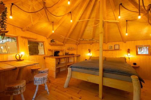 a bedroom with a bed in a wooden cabin at Treehouse Bojnice in Bojnice