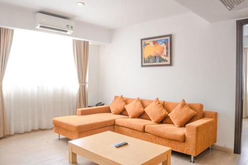 a living room with a couch and a coffee table at Bao Son International Hotel in Hanoi