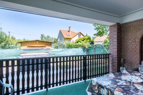 a balcony with a view of a swimming pool at Napsugár Vendégház in Poroszló