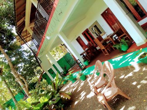 a room with a house with a pool and some plants at Sigiriya Palace View in Sigiriya