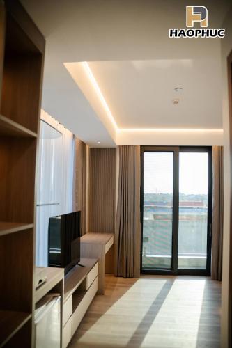 a hotel room with a television and a large window at Hào Phúc Hotel 