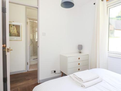 a bedroom with a white bed and a mirror at Valley Lodge 37 in Callington