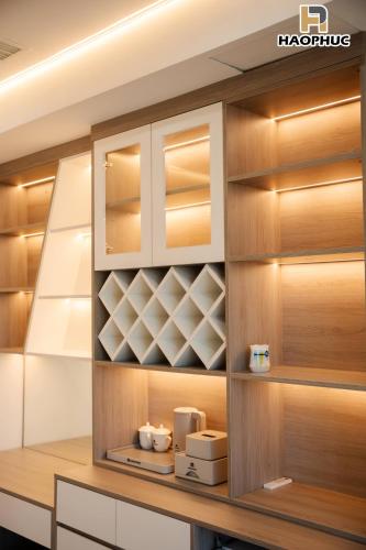 a cupboard with wooden doors and shelves in a kitchen at Hào Phúc Hotel 